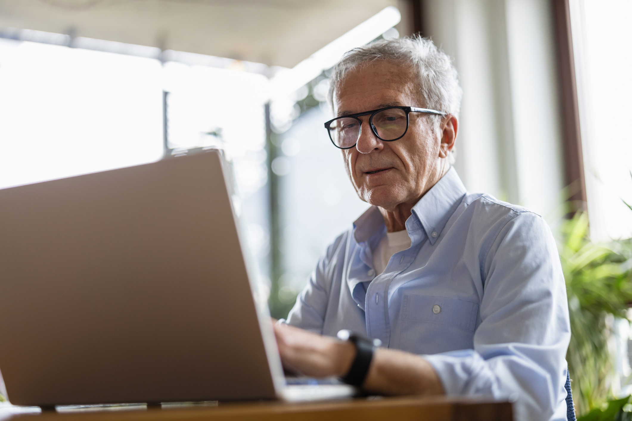 Senior man using laptop at home