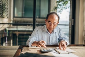 Senior man doing finances at home