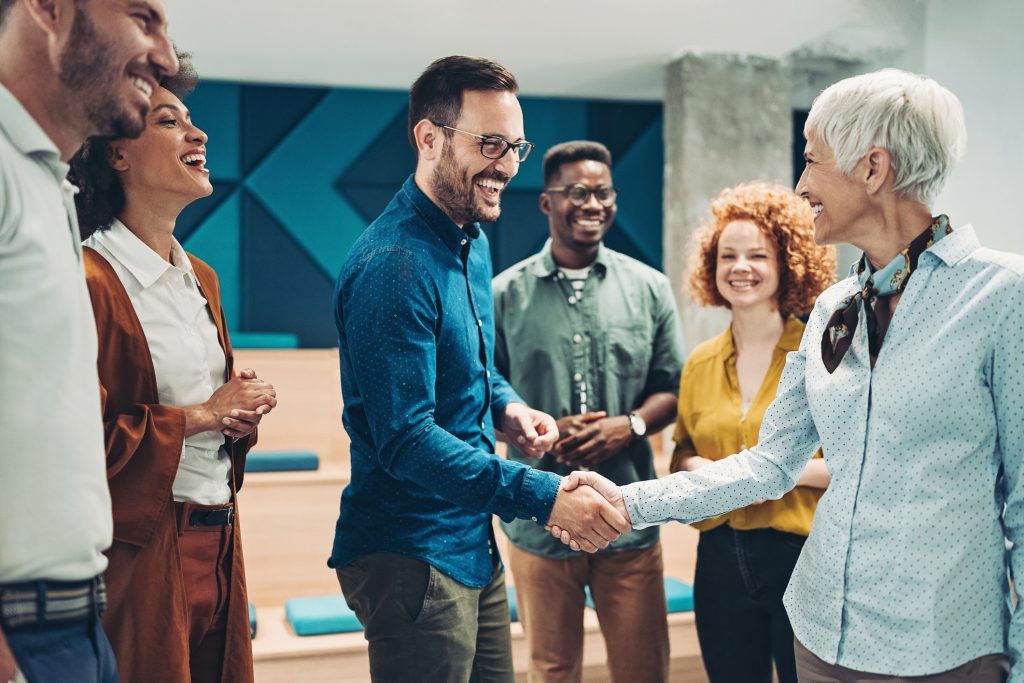 Smiling business persons shaking hands